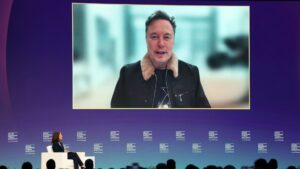 Elon Musk says he will spend a lot less on